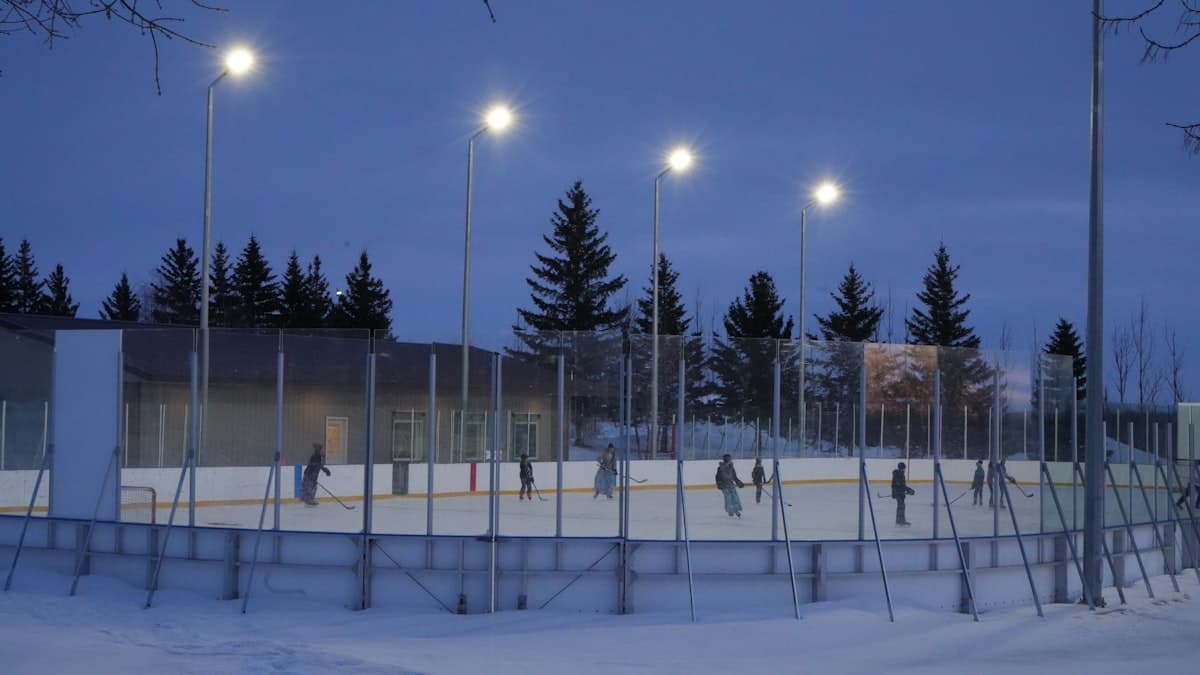 An outdoor community rink under lights at night
